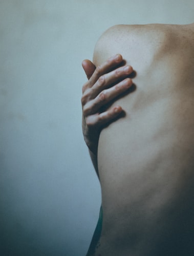person holding shoulder blade